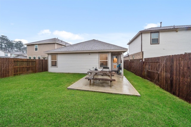 rear view of house featuring a yard and a patio