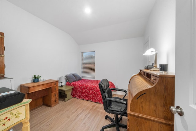 bedroom featuring vaulted ceiling and light wood-type flooring