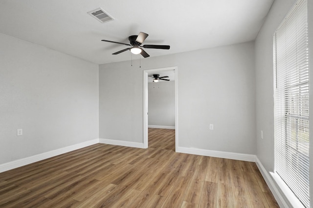 unfurnished room with light hardwood / wood-style flooring and ceiling fan