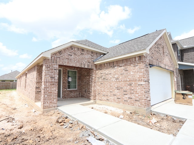 21666 Sandy Dune Dr, Cypress, TX 77433 - view of front of home featuring brick siding, an attached garage, and a shingled roof