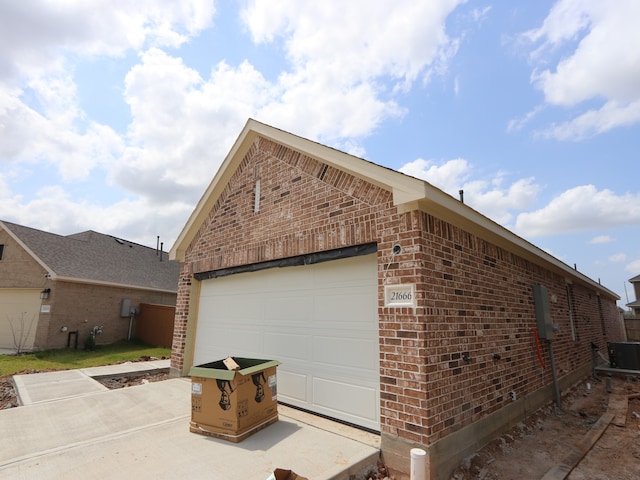 21666 Sandy Dune Dr, Cypress, TX 77433 - view of property exterior with brick siding, cooling unit, and concrete driveway