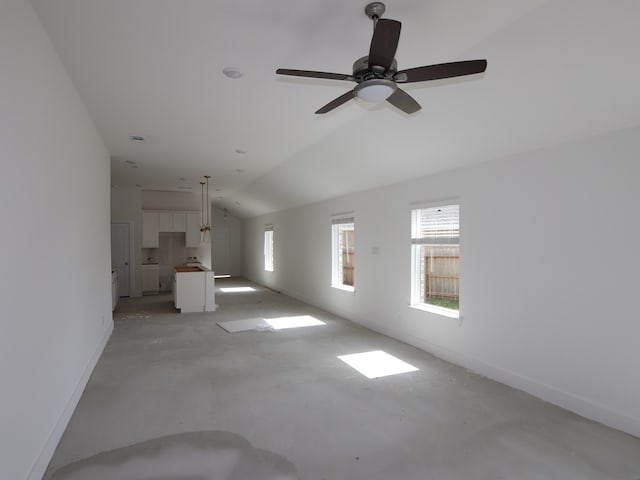 21666 Sandy Dune Dr, Cypress, TX 77433 - unfurnished living room with vaulted ceiling, ceiling fan, and concrete floors