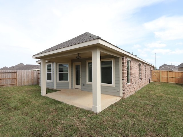 21666 Sandy Dune Dr, Cypress, TX 77433 - back of property featuring brick siding, a patio, and a fenced backyard