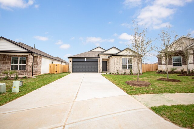 3013 Plains Cir, Brookshire, TX 77423 - view of front of property with a front yard, an attached garage, driveway, and fence