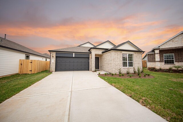 3013 Plains Cir, Brookshire, TX 77423 - view of front of house featuring driveway, fence, a yard, a garage, and brick siding