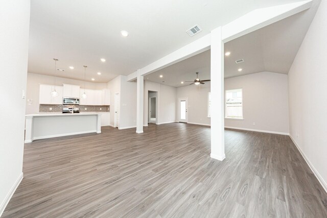 3013 Plains Cir, Brookshire, TX 77423 - unfurnished living room featuring visible vents, a ceiling fan, recessed lighting, light wood-style floors, and vaulted ceiling