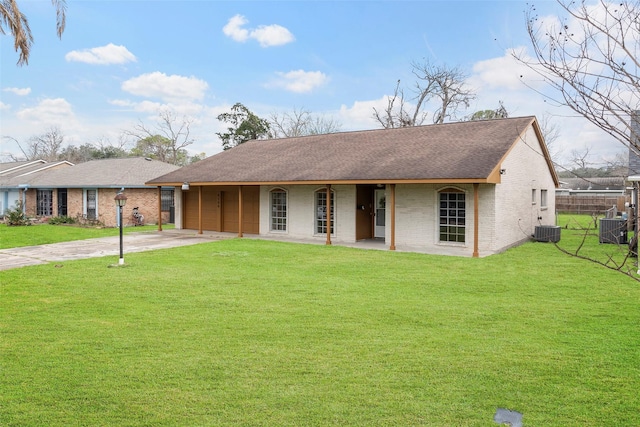 ranch-style home featuring a front lawn and central air condition unit