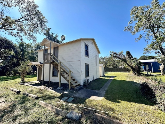 view of side of property with a lawn