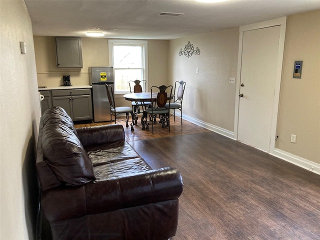 living room featuring dark wood-type flooring