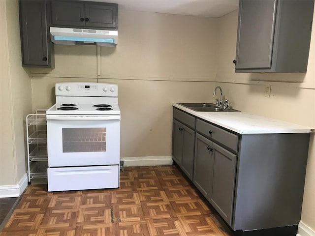 kitchen with white range with electric cooktop, sink, dark parquet floors, and gray cabinetry