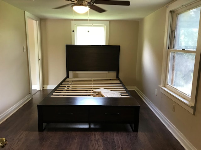 unfurnished bedroom featuring ceiling fan and dark hardwood / wood-style flooring