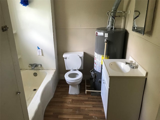 bathroom with gas water heater, hardwood / wood-style floors, vanity, and toilet