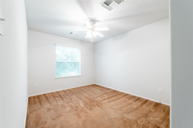 empty room featuring carpet floors and ceiling fan