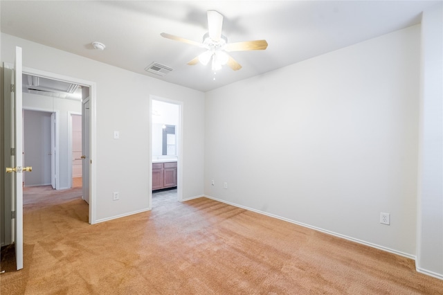 unfurnished bedroom with light colored carpet and ensuite bathroom