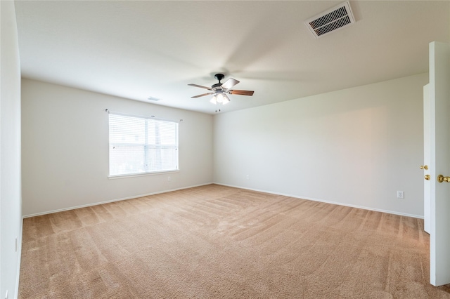 carpeted spare room featuring ceiling fan