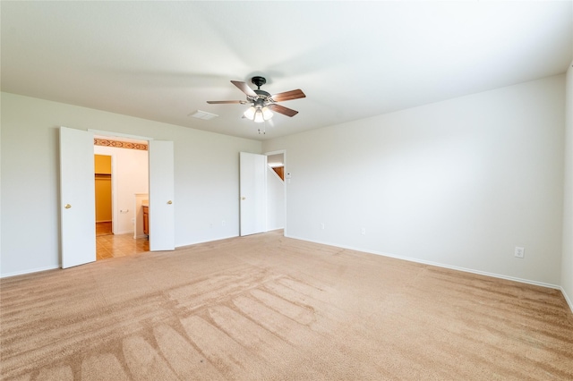 unfurnished bedroom with ceiling fan and light carpet