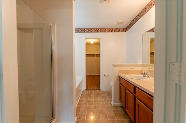 full bathroom featuring vanity, toilet, and separate shower and tub