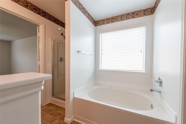 bathroom with tile patterned floors and shower with separate bathtub