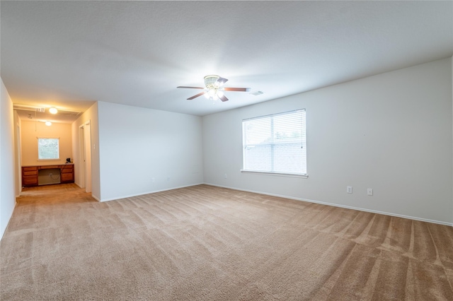 carpeted empty room featuring ceiling fan