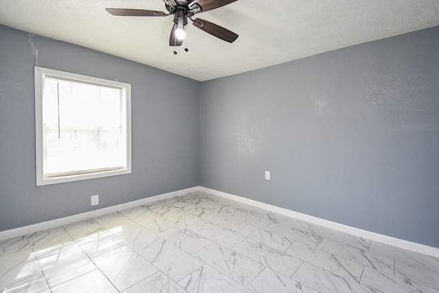 spare room featuring ceiling fan and a textured ceiling