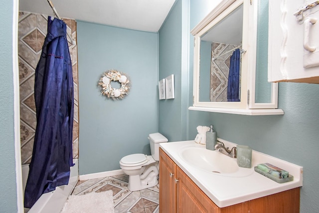 bathroom with vanity, tile patterned flooring, and toilet