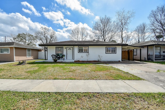 single story home featuring a front yard and a carport