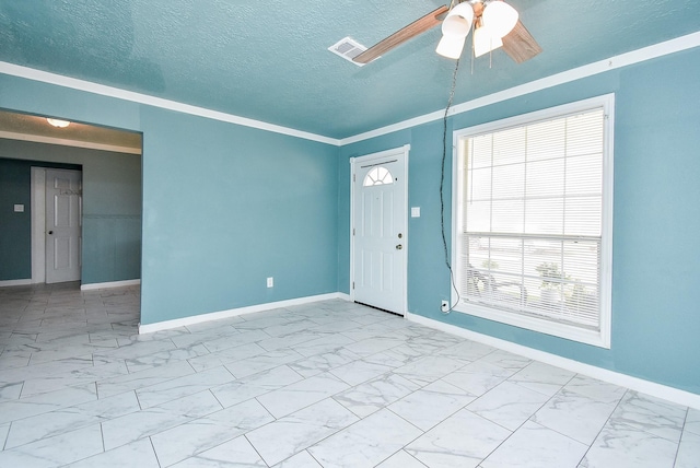 unfurnished room featuring ornamental molding, a textured ceiling, and ceiling fan