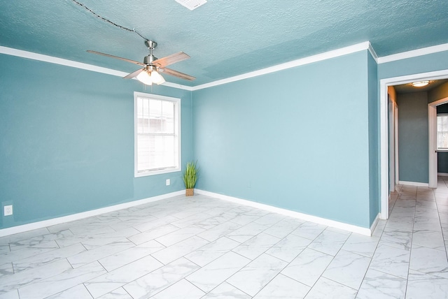 spare room with ceiling fan, ornamental molding, and a textured ceiling