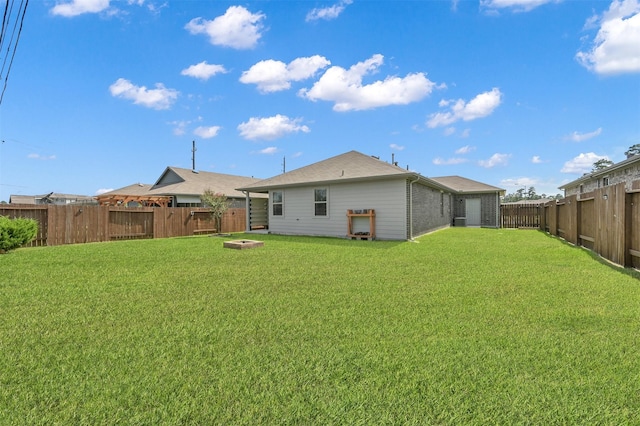 rear view of property with a lawn