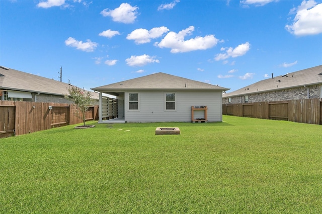 back of house with a lawn and a patio