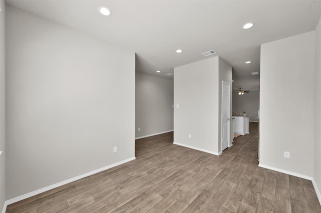 spare room with ceiling fan and light hardwood / wood-style floors