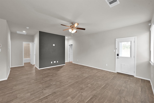 unfurnished living room with hardwood / wood-style flooring and ceiling fan