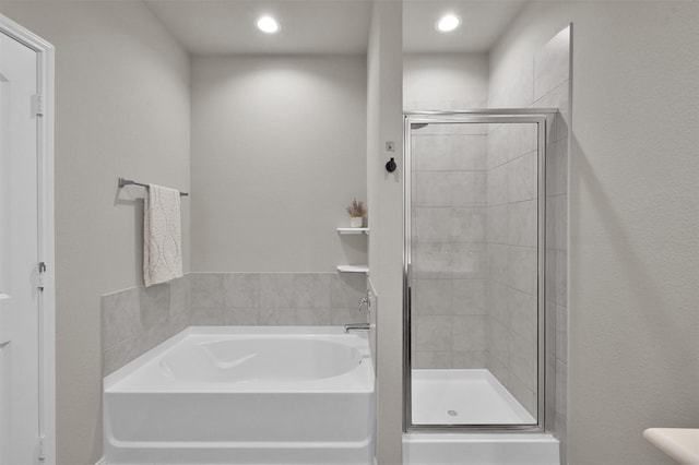 bathroom with separate shower and tub