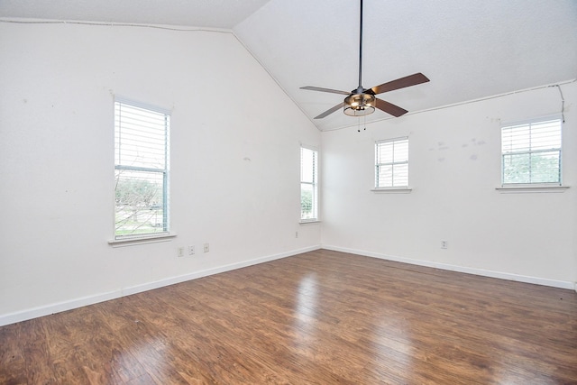 spare room with vaulted ceiling, dark hardwood / wood-style floors, and ceiling fan