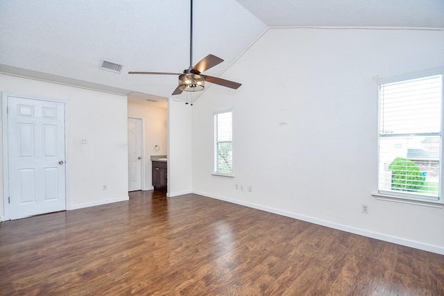 spare room with ceiling fan, lofted ceiling, and dark hardwood / wood-style flooring