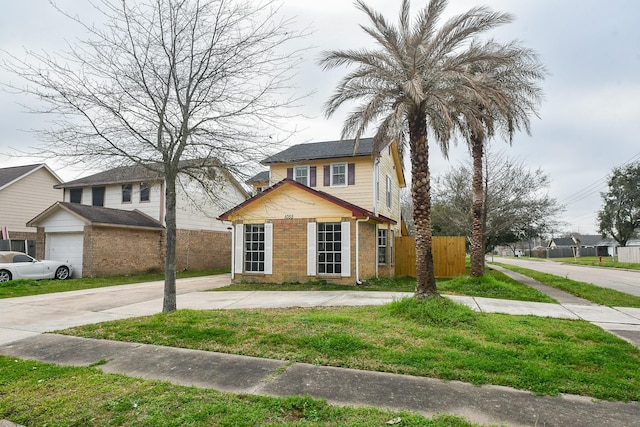 view of front of house featuring a garage and a front lawn