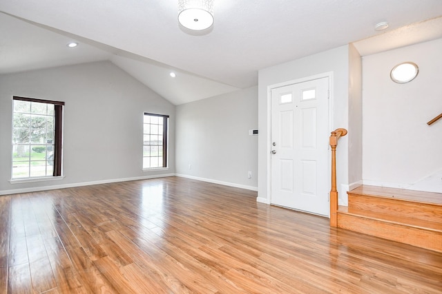 foyer with lofted ceiling and light wood-type flooring