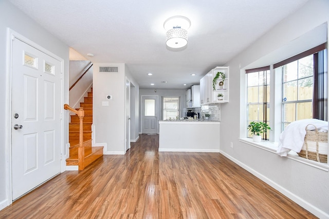 entryway with light hardwood / wood-style flooring