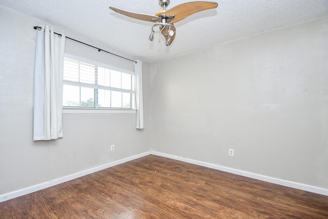 spare room featuring ceiling fan, dark hardwood / wood-style floors, and a textured ceiling