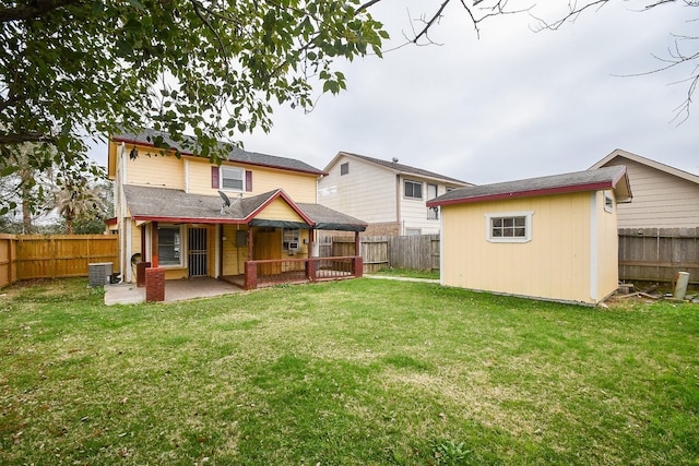 rear view of property with central AC unit, an outbuilding, a lawn, and a patio