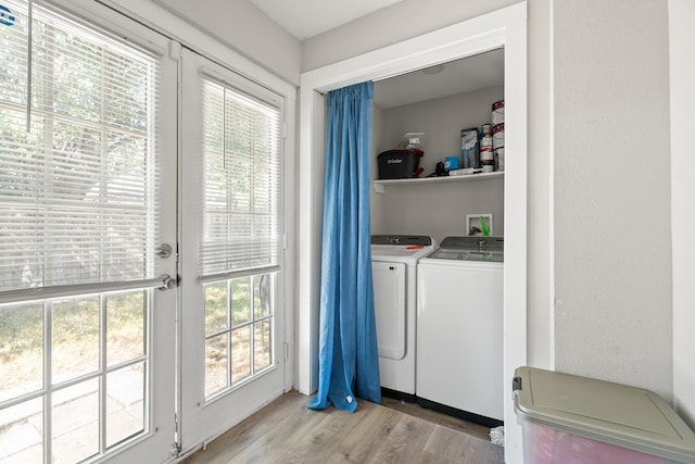 clothes washing area featuring separate washer and dryer and light wood-type flooring