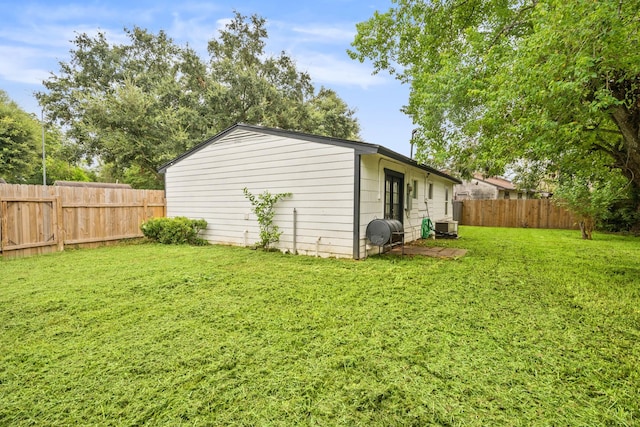 view of property exterior with ac unit and a lawn