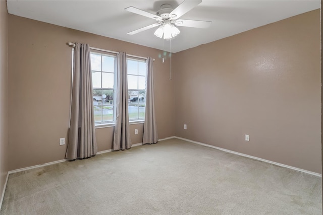 empty room featuring light colored carpet and ceiling fan