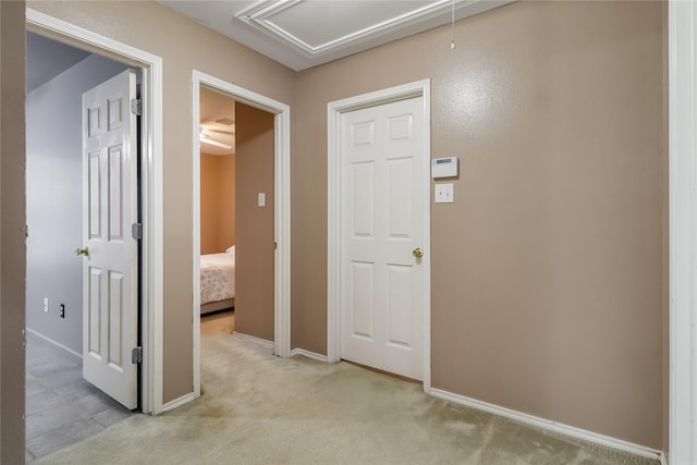 corridor featuring light colored carpet