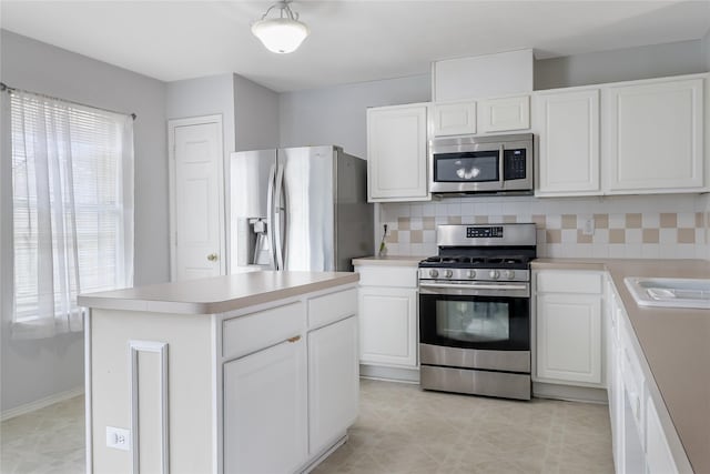 kitchen with white cabinetry, tasteful backsplash, a center island, and appliances with stainless steel finishes