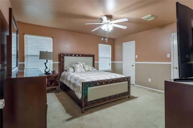 bedroom with light carpet and ceiling fan