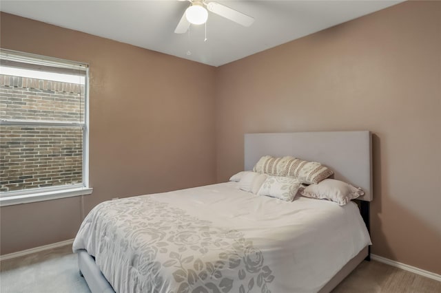 bedroom featuring light carpet and ceiling fan