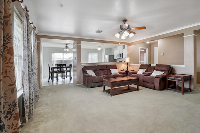 carpeted living room featuring crown molding