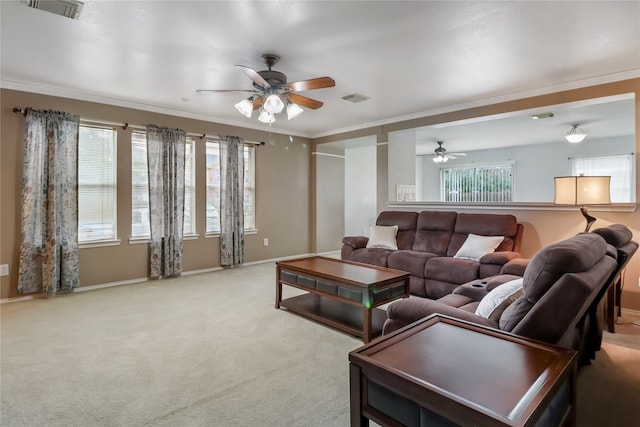 carpeted living room with crown molding and ceiling fan