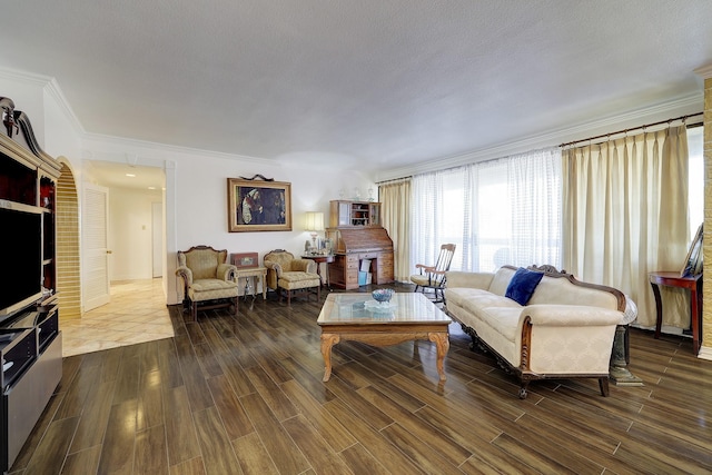 living room with crown molding, dark hardwood / wood-style floors, and a textured ceiling